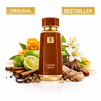Braune Parfumflasche „Liquid Brun“ mit goldenen Details, inszeniert vor Limetten, Zimtstangen, Vanille, Gewürzen und weißen Blüten; oben mit den Labels „Original“ und „Bestseller“ gekennzeichnet.